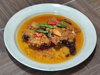 Tilapia with yellow curry, a traditional Indonesian dish, which has a delicious taste, beautifully presented.