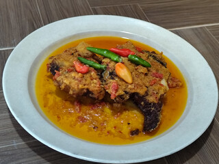 Tilapia with yellow curry, a traditional Indonesian dish, which has a delicious taste, beautifully presented.