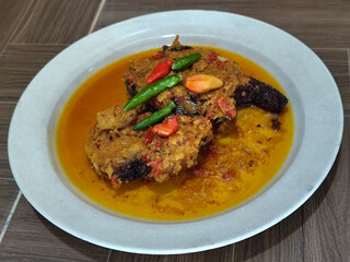 Tilapia with yellow curry, a traditional Indonesian dish, which has a delicious taste, beautifully presented.