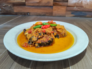 Tilapia with yellow curry, a traditional Indonesian dish, which has a delicious taste, beautifully presented.