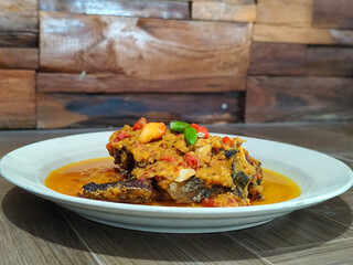 Tilapia with yellow curry, a traditional Indonesian dish, which has a delicious taste, beautifully presented.