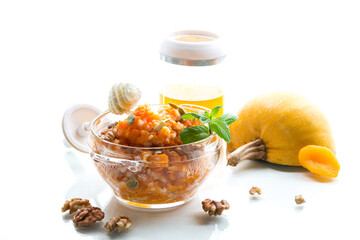 Cooked rice with pumpkin, honey and nuts. Isolated on white background