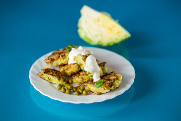 vegetable cutlets from cabbage with peas on a blue background