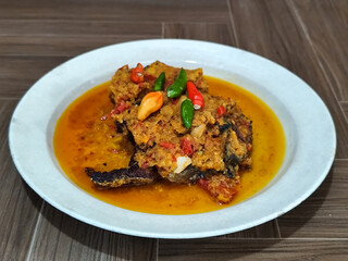 Tilapia with yellow curry, a traditional Indonesian dish, which has a delicious taste, beautifully presented.