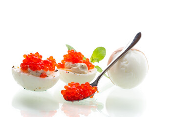 boiled eggs with red caviar on a white background