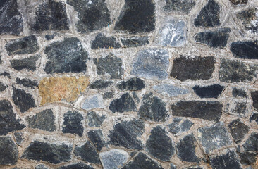 A wall made of stone and gray rocks