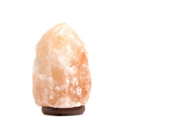 Salt lamp with wooden stand on a white background.