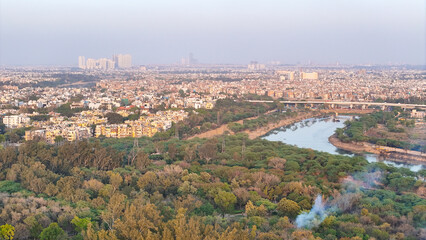 Dense Housing and Tree-Covered Roads in Delhi Slum – Aerial Evening View