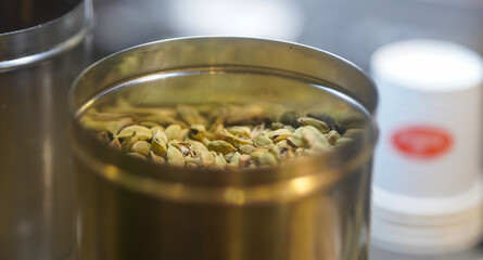 Green Cardamom Pods in Brass Container – Aromatic Indian Spice Close-Up