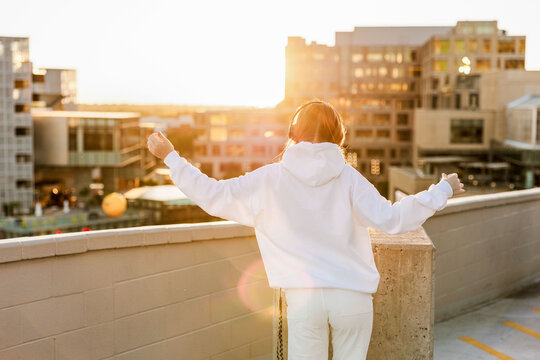 Generation z teen enjoying sunset on rooftop in the city