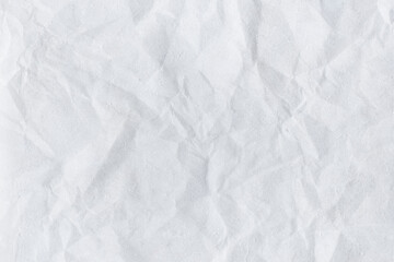 Crumpled white paper with rough textured surface and blank sheet background
