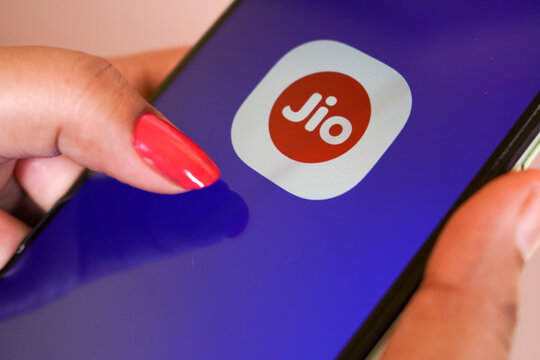 Jhargram, West Bengal, India - May 16, 2025: A woman holding a smartphone and My jio app icon on mobile screen. Mobile service provider on phone app.