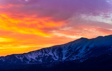 highland mountain landscape of beautiful sunset or sunrise behind nice mountain peaks and slopes in...