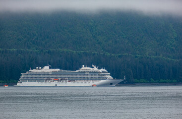 Luxury cruiseship cruise ship liner Orion and kayaks boat in Hoonah Icy Strait Point Bay, Alaska...