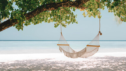 Romantic beach swing hammock over white sand