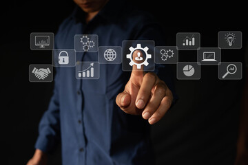The concept of creating an automation control system with modern technology for business management. Businessman hand icon touching gears shows the operation of automation software.