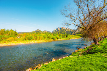 Peak Tri Koruny or Trzy Korony during day with green meadow and trees in spring. Pieniny National park in Slovakia and Poland . © Zedspider