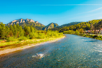 Peak Tri Koruny or Trzy Korony during day with green meadow and trees in spring. Pieniny National park in Slovakia and Poland . © Zedspider