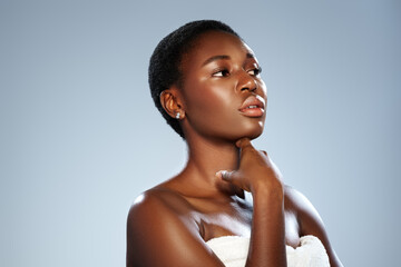 Elegant portrait of a woman posing thoughtfully against a light backdrop