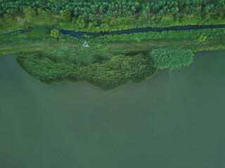 Drone shot of green island surrounded by water