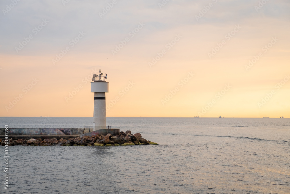 Aufkleber bosphorus view at sunset with lighthouse illuminating the shoreline and ships in the distance over c