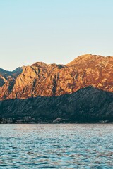 Rugged slopes and calm bay at golden hour