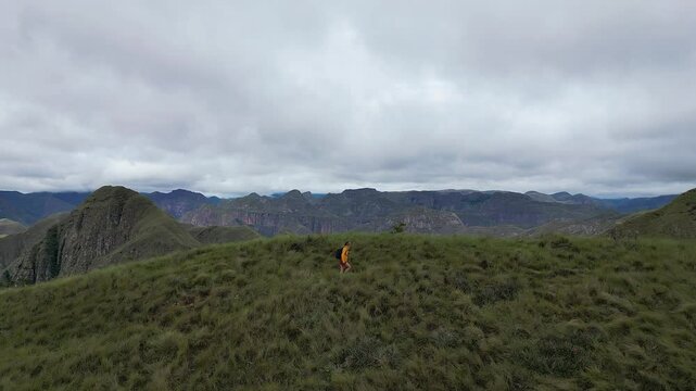 Panoramic view of hiker on rugged mountainous Codo de los Andes trail