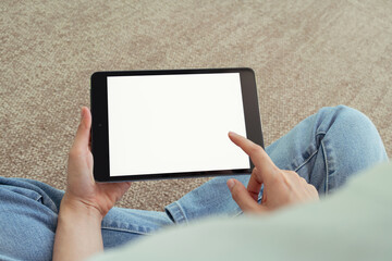 Hand holding digital tablet with blank screen for graphic display montage in the building area, mockup display for lifestyle and wireless technology.