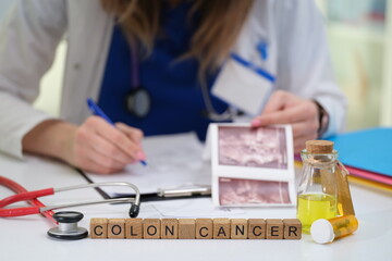 A dedicated physician reviews detailed colon cancer images and provides notes in a clinical healthcare setting