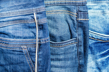 Close-up of three denim jeans pockets with texture