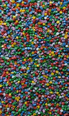 Vibrant assortment of colorful plastic granules creates a lively and visually stimulating background texture perfect for creative designs