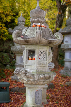 Osaka, Japan - December 2024: Scenic view of Katsuoji Temple in Minoh during peak autumn season. Beautifully framed by vibrant red and orange maple leaves, reflecting the serene atmosphere of autumn.