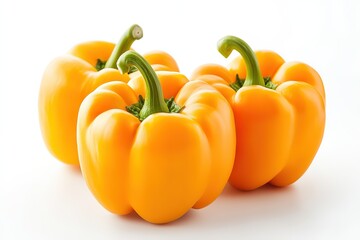 Three vibrant orange bell peppers on white background