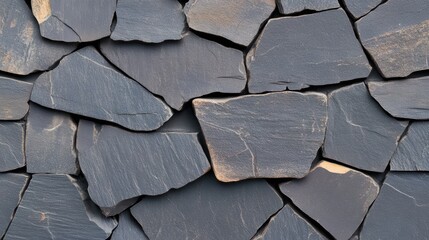 Textured Slate Mosaic: A detailed, close-up shot showcases the beauty of a natural slate mosaic wall, its irregular, gray stones fitting together to create a pattern.