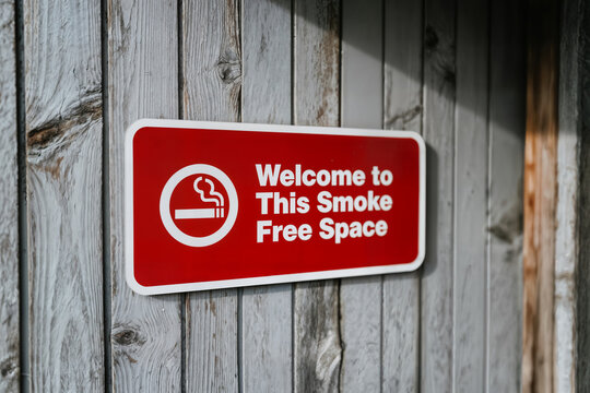 closeup of a welcome to this smoke free space sign on a wooden structure symbol or pictogram that means no smoking on it concept sigara i&ccedil;ilmez tabela levha uyari
