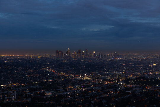 A panoramic night view of Los Angeles showcases the city’s glowing skyline illuminated by countless lights