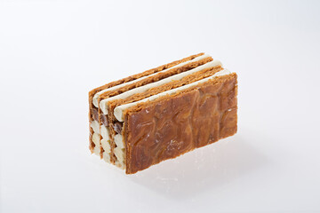 Slice of Multi-Layered Honey Cake (Medovik) with Cream Filling on White