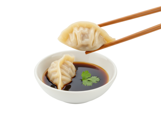 Isolated Steamed Dumpling Held by Chopsticks Dipped in Soy Sauce