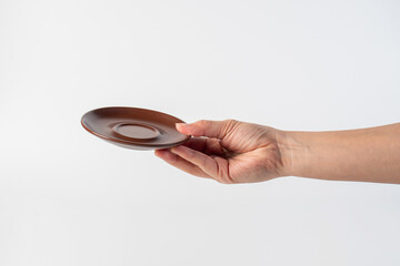 Brown coffee cup plate and hand, cup on white background