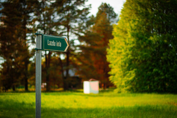 Close-up of a green directional street sign reading 