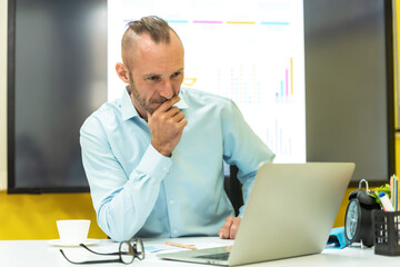 Fototapeta premium Male Caucasian businessman working with computer laptop in office