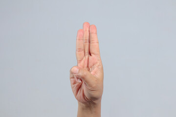 Three fingers raised gesture commonly used for counting or symbolic salute
