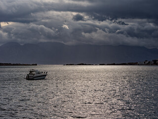 Calm Schisma Elountas waters, dark skies
