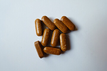 View of multiple brown caplets of iron dietary supplement from above