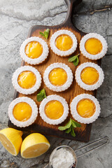 Delicious sweet lemon crud cookies sprinkled with powdered sugar  closeup on wooden board on the table. Vertical top view from above