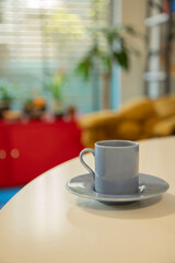 Modern Coffee Cup with Green Plant on Bright Office Counter