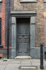 Georgian style grey front door with decorated jambs in London