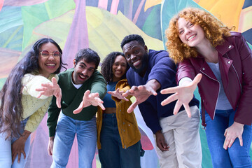 Group of young people reaching out with open hands