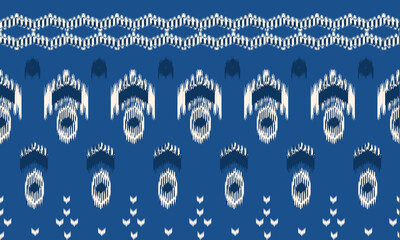 A seamless traditional ikat textile pattern in indigo blue and white tones, showcasing intricate geometric and cultural motifs.