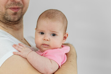 Baby care. Father holding baby daughter in arms